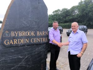 Nigel Long MD of Longacres Garden Centre and Terry Burch of Bybrook Barn shake hands on the completion of the acquisition